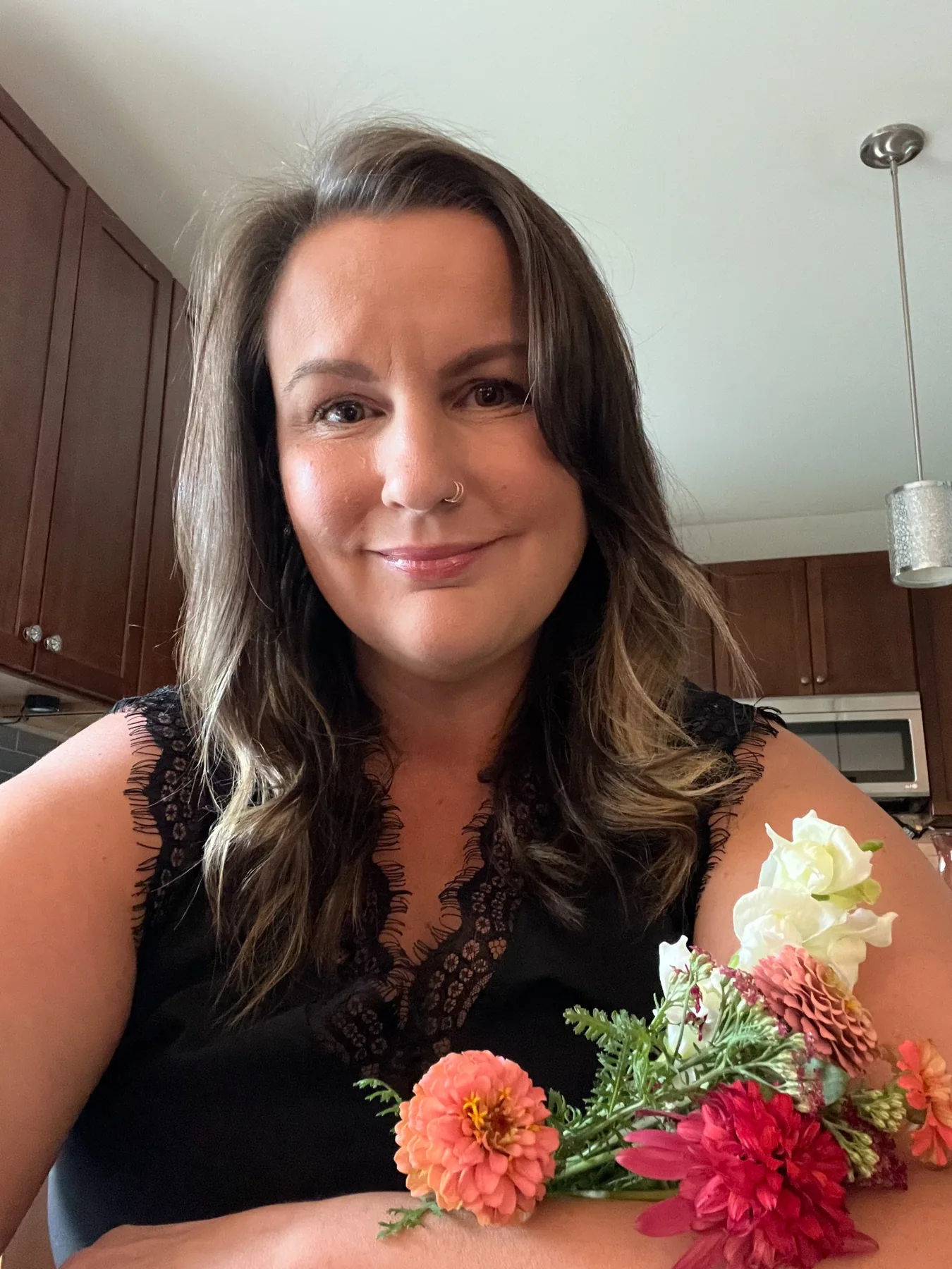 Founder of O&O Wild Prose Floral holding fresh flowers
